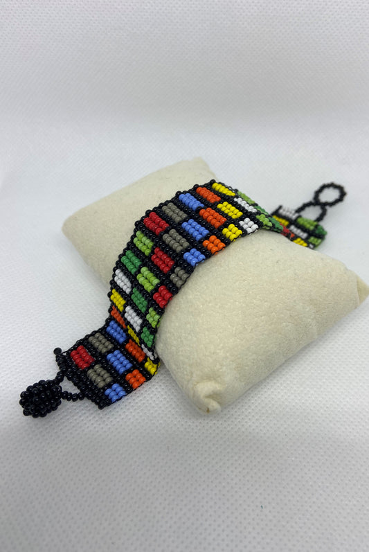 Chaquira bracelet made in form of little squares and colors
